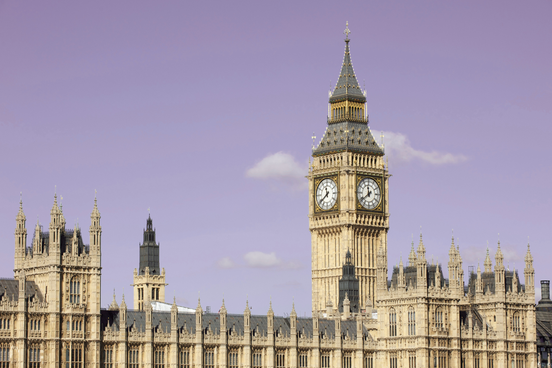 The exterior of UK parliament, with a view of the river thames. The sky has been edited to look purple.