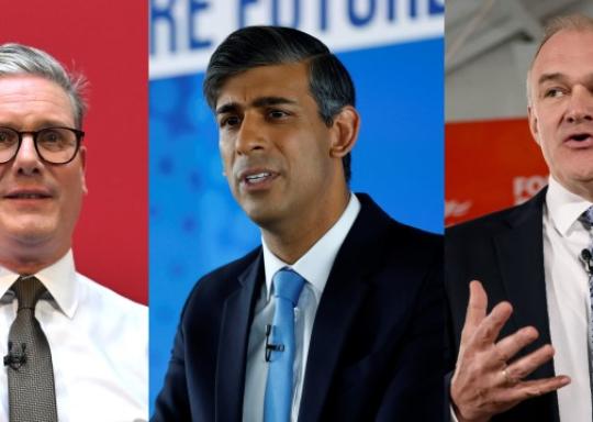 image shows in order: keir starmer wearing glasses, wearing a white shirt and red tie in front of a red background. Rishi Sunak wearing a blue jacket, blue tie, stood in front of a blue background. Ed Davey in dark suit, with a purple tie. 