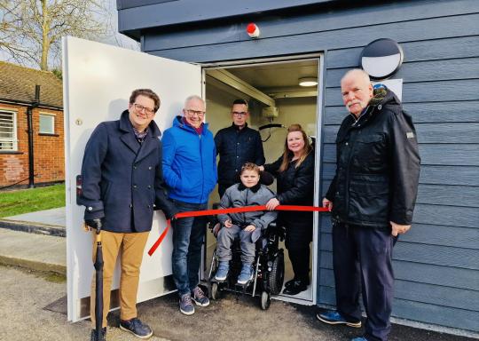 Image of Shelley, Fraser and others at the opening of the accessible toilets in their local area, after hard campaigning