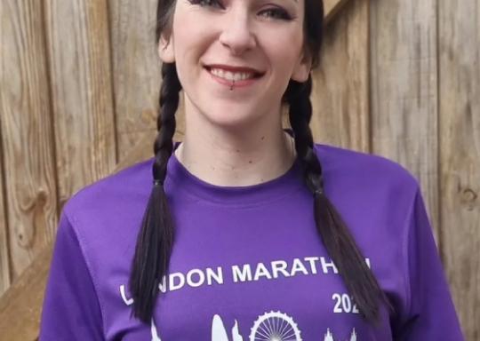 Image of Charlotte in a DR UK Marathon shirt, smiling